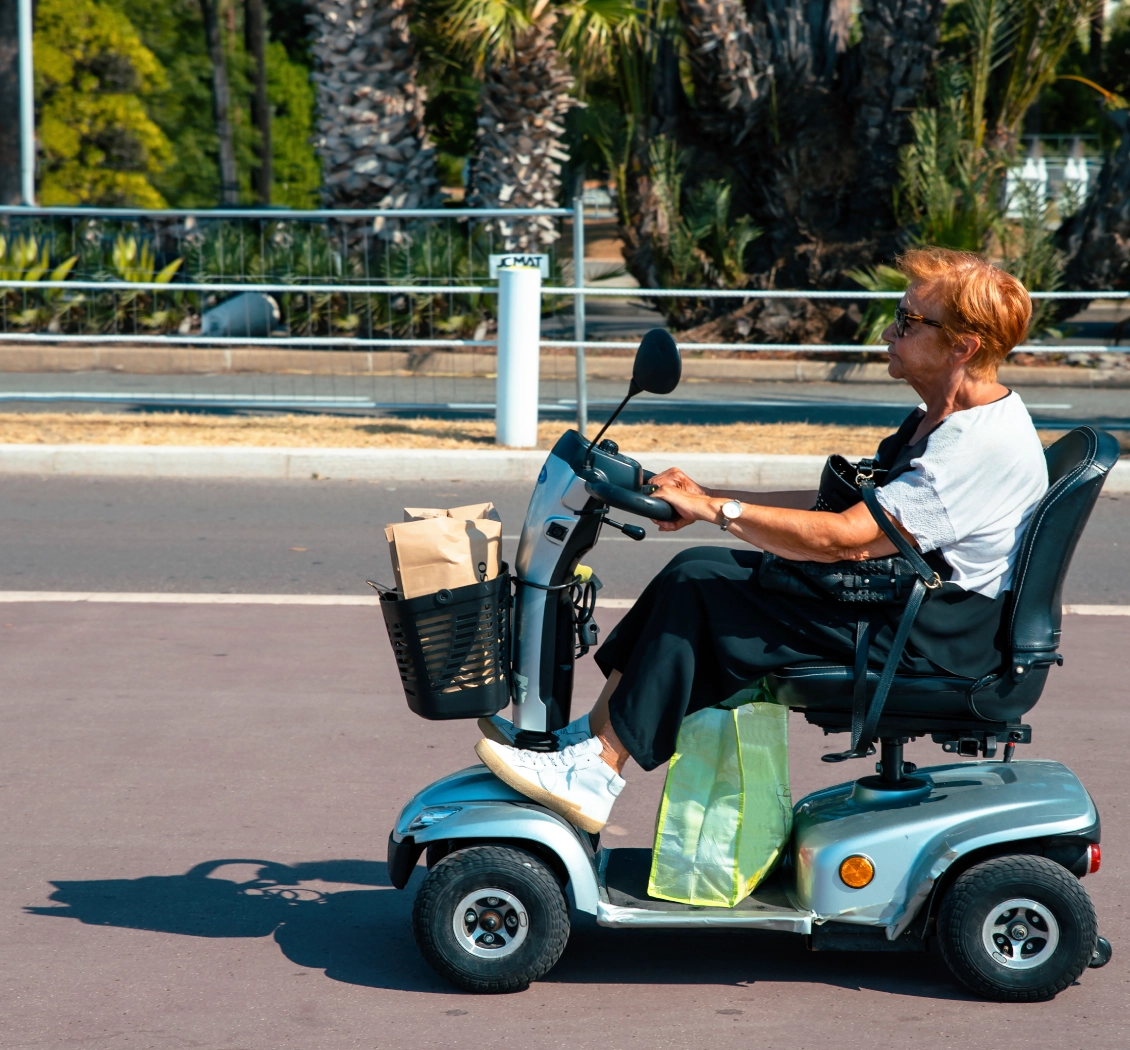 Woman riding a mobility scooter outdoors