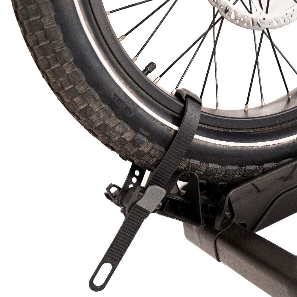 Bike wheel secured to rack with strap