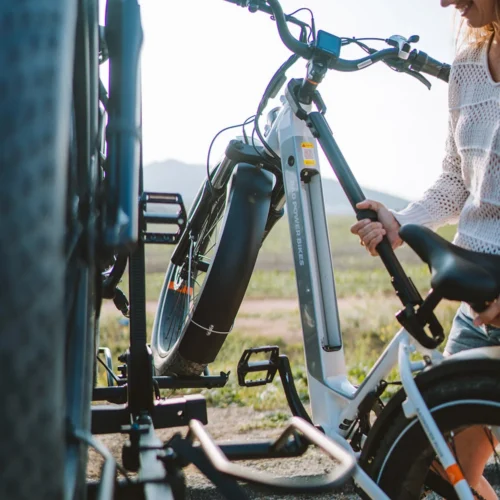 Woman loading e-bike onto car rack