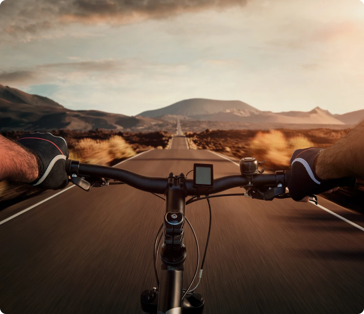 Cycling on open road at sunset